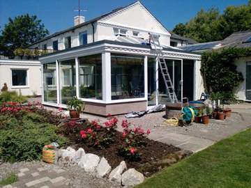 Mr & Mrs W. Caldy Wirral . Design and biuld . Orangery - K2 Roof system. Aluminium External cappings Glazed with Celsius one. Large Marine finish S Therm Sliding doors. Double glazed. Roof covering Sarnafil . Fascia Bespoke Timber to match house